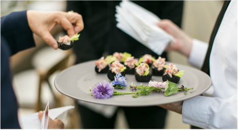 A man takes an hors d'oeuvre from a tray at an L.A. LIVE event.
